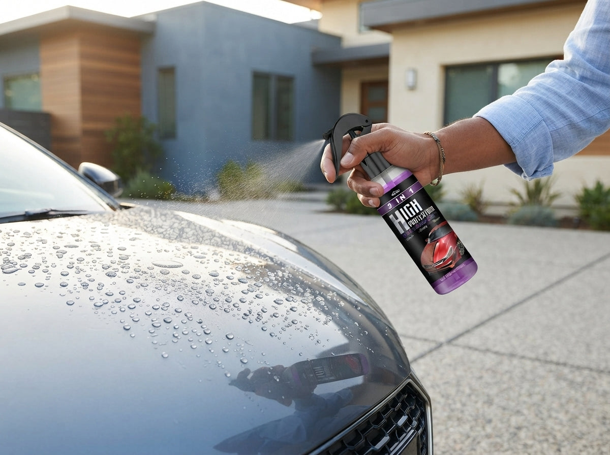 A person applying hydrophobic nano coating spray to a car hood in a bright, modern home driveway.